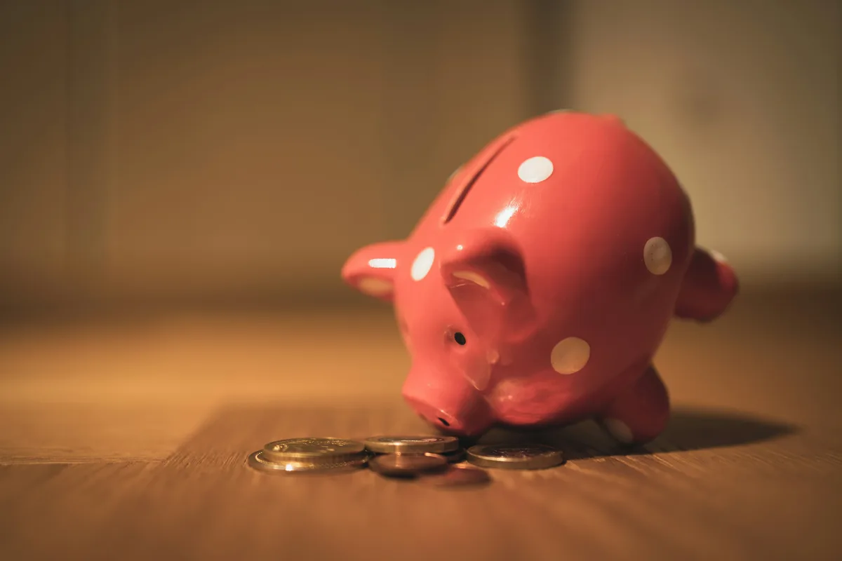 Pink piggy bank on a wooden table illustrating retirement savings and IRA contribution strategies